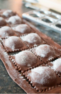 Some different ravioli - chocolate ravioli with cream cheese and aromatic pear sauce